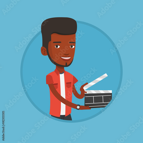 Smiling man holding an open clapperboard.