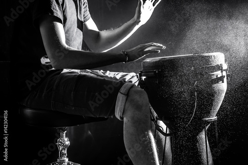 man playing the djembe, african drum, musical concept, beautiful lighting on the stage