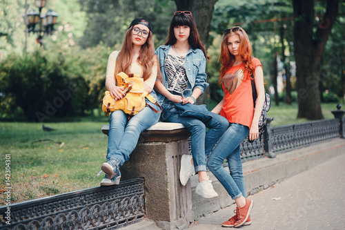 three young girls walking in the park © hetmanstock2