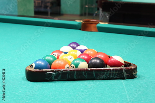 Fényképezés Multicolored billiard balls for snooker on green pool billiard table in a triang