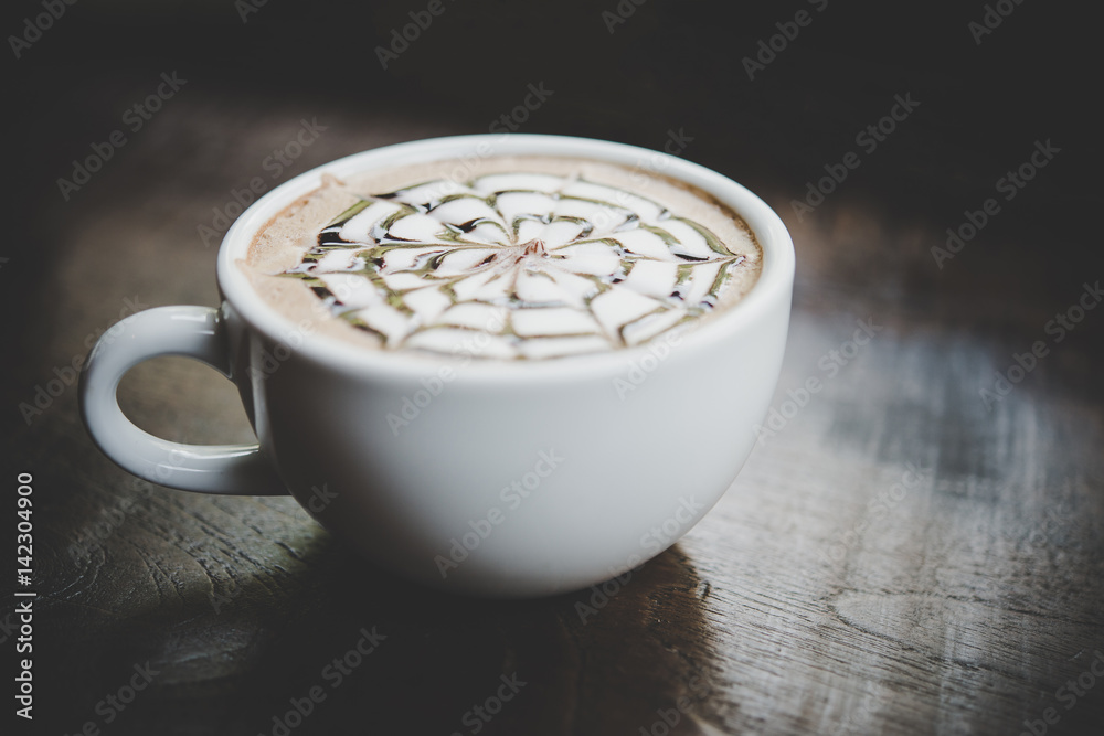 A cup of coffee on wooden table in cafe. A cup of coffee on wooden table in cafe.