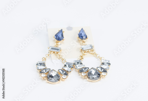 Silver earrings with jewels on white background