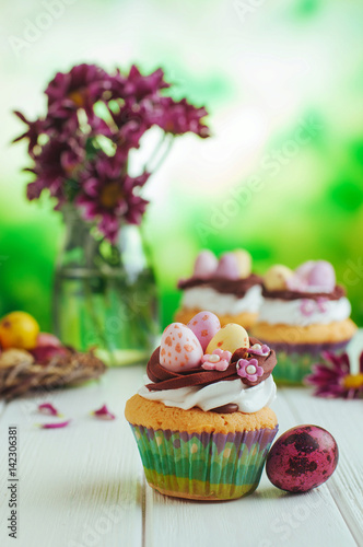 Closeup of Easter nest shape cupcakes on white background
