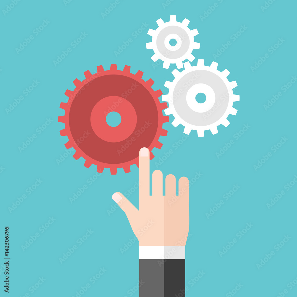 Hand touching cog wheels Hand touching cog wheels