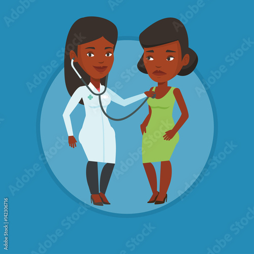 Doctor listening to chest of patient.