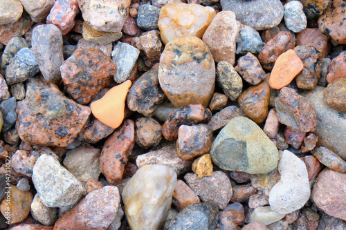 different colored stones on the sea shore