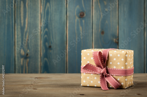 Polka dot gift box on wooden table