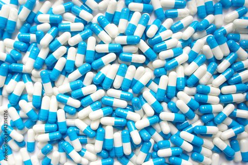 blue and white pill capsules background. Close-up