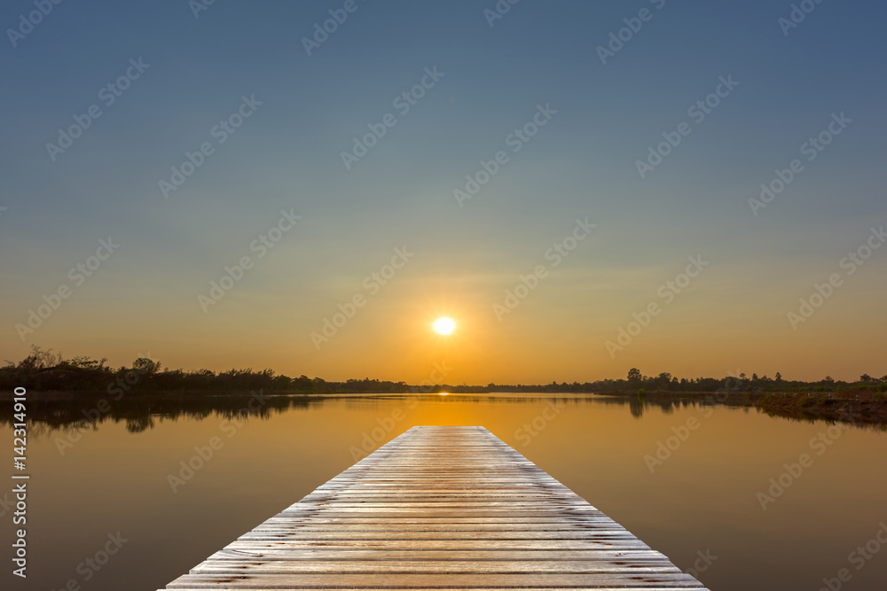 View from a wooden bridge and sunset over the lake