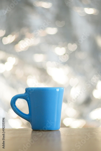 Cup with heart at bokeh background. Soft focus
