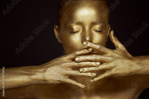 Portrait unearthly Golden girls, hands near the face. Very delicate and feminine. The eyes are closed.Frame of hands