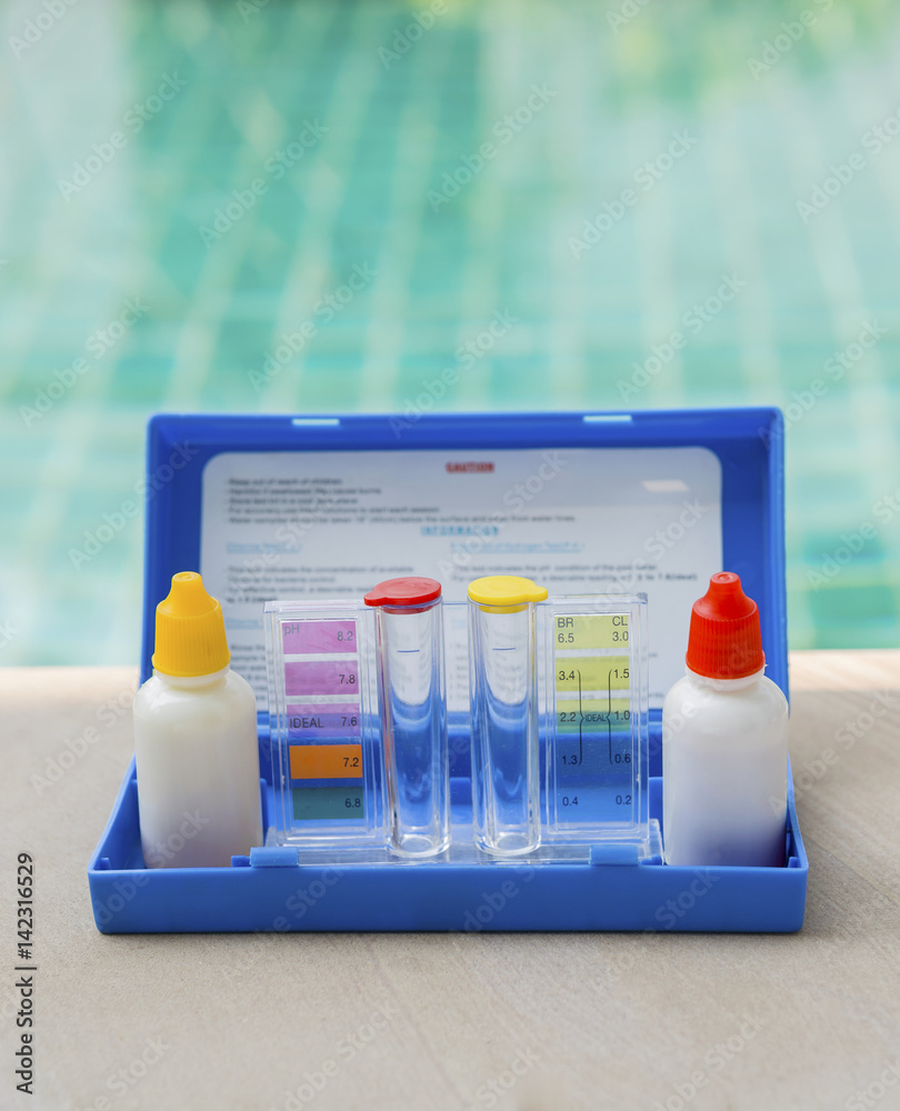 Liquid swimming pool water testing test kit over swimming pool