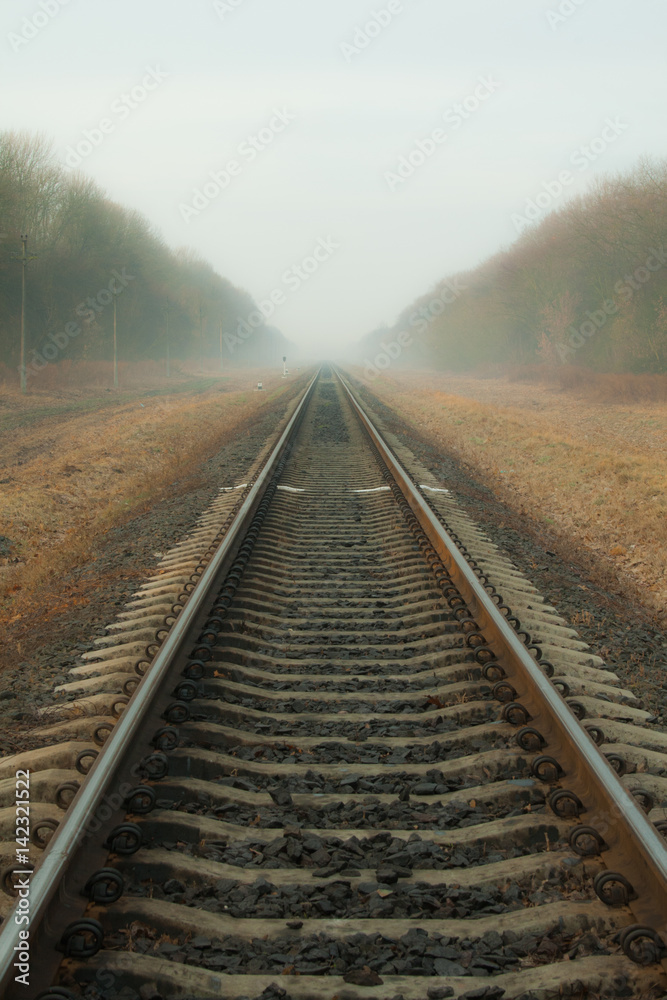 Railways at foggy weather morning. Railway in the autumn