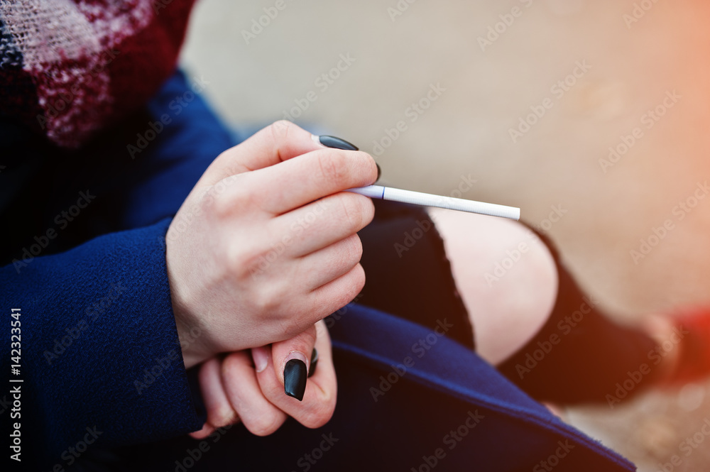 Hand of girl with cigarette. Stop smoking social problem.
