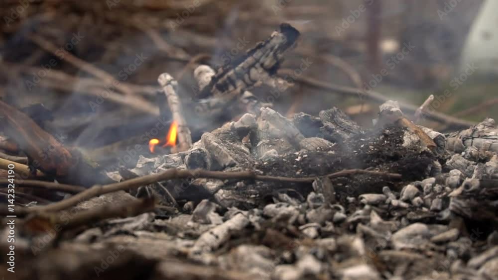 Smoldering remains from the campfire. Slow motion Smoldering remains from the campfire. Slow motion