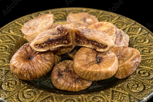 Dried figs in golden plate