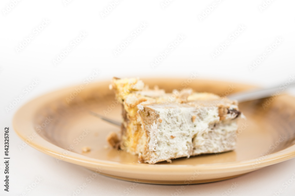 Piece of cake on the plate isolated over white background Piece of cake on the plate isolated over white background