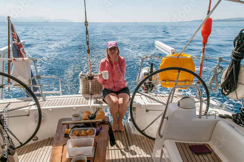 Woman enjoying coffee on a sailing yacht