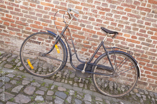Bicycle on Cobble Stone against Brick Wall
