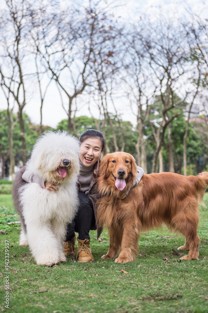 Girl and dogs, outdoors on the grass Girl and dogs, outdoors on the grass