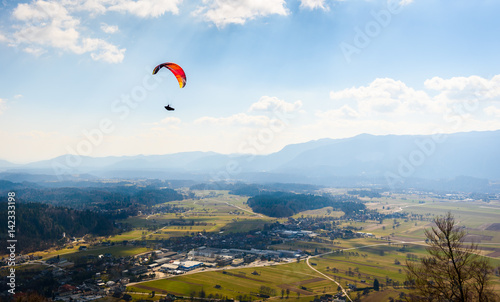 Paraglider is flying in the valley.