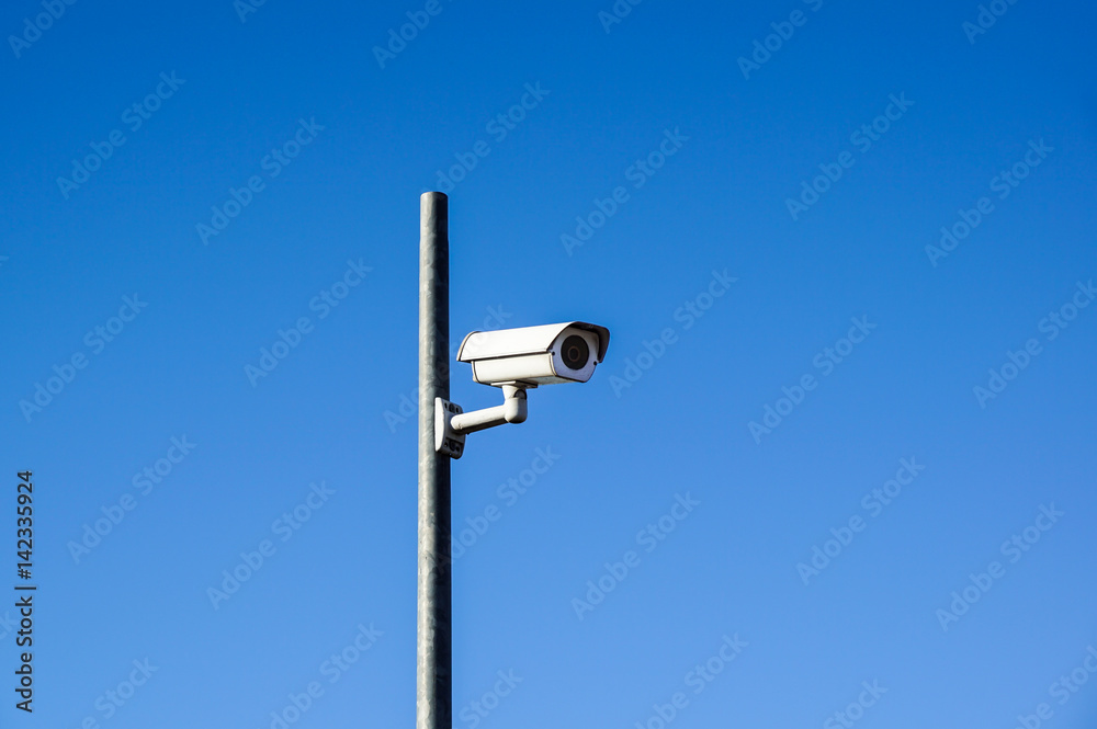 Laterally camera on a post in bue sky