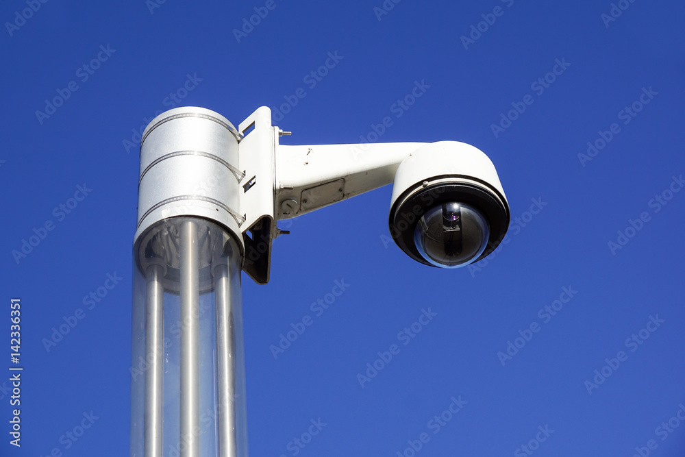 High tech overhead security camera with a blue sky High tech overhead security camera with a blue sky