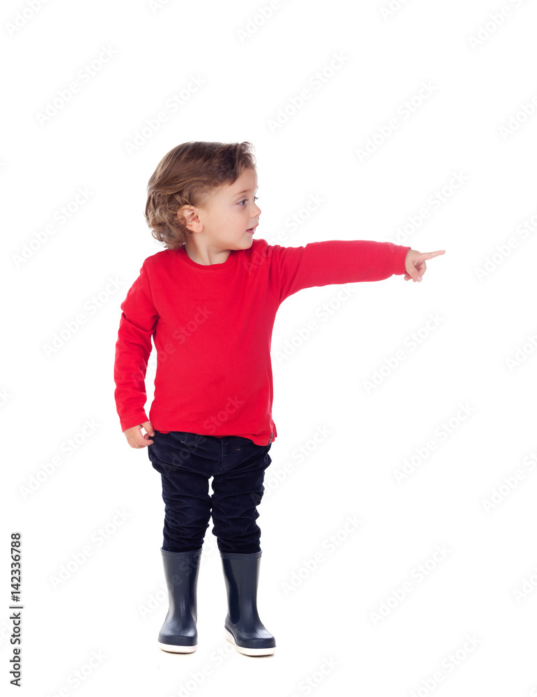 Adorable baby with red shirt pointing with his finger Adorable baby with red shirt pointing with his finger