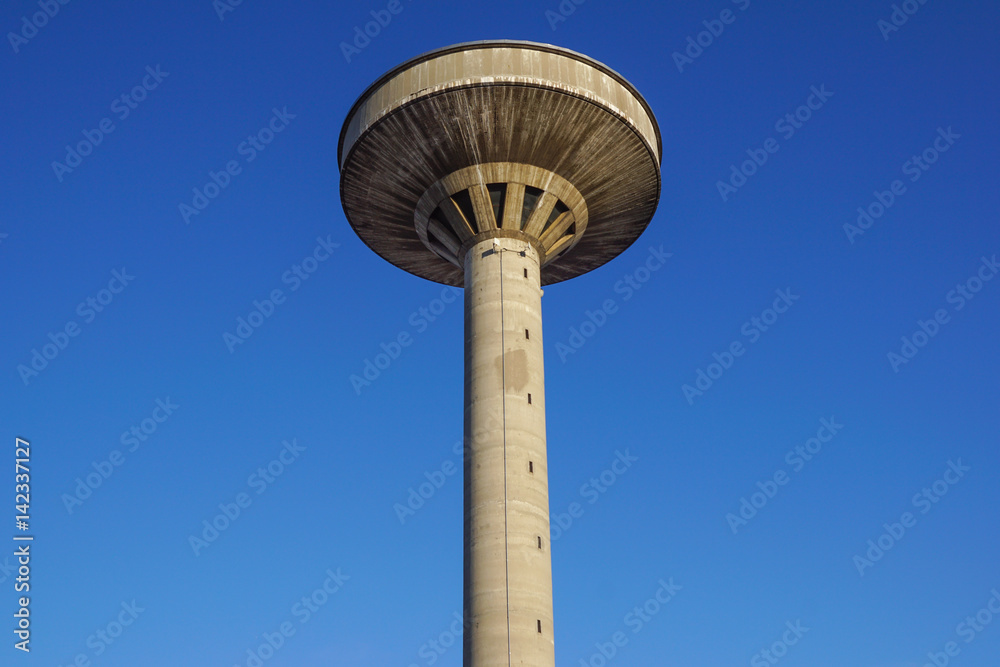 concrete two water towers against blue sky concrete two water towers against blue sky