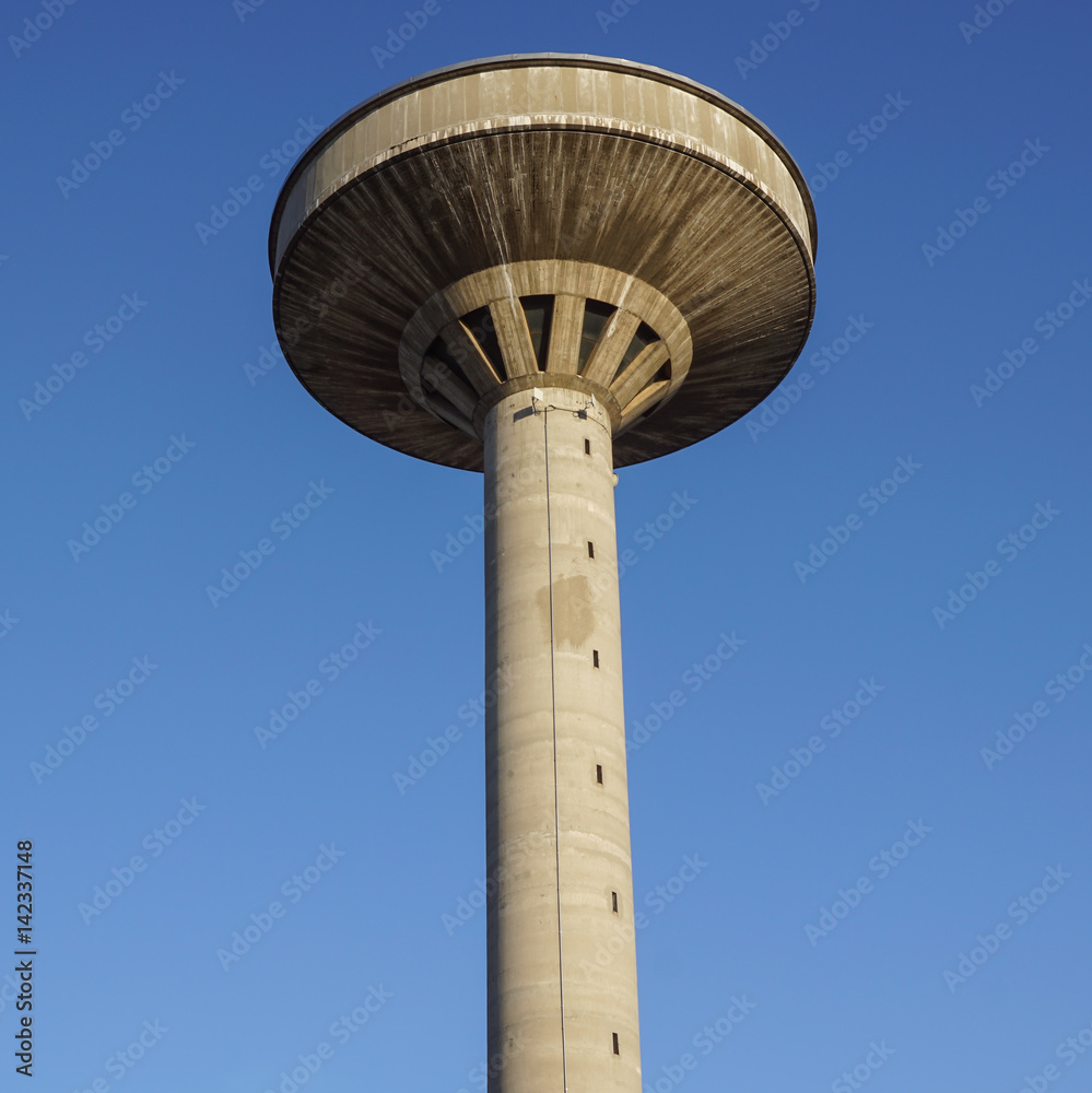 concrete two water towers against blue sky concrete two water towers against blue sky