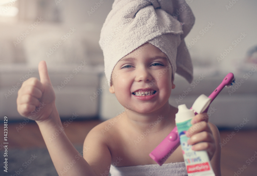 Little Caucasian girl brush her teeth in the bathroom. Little Caucasian girl brush her teeth in the bathroom.