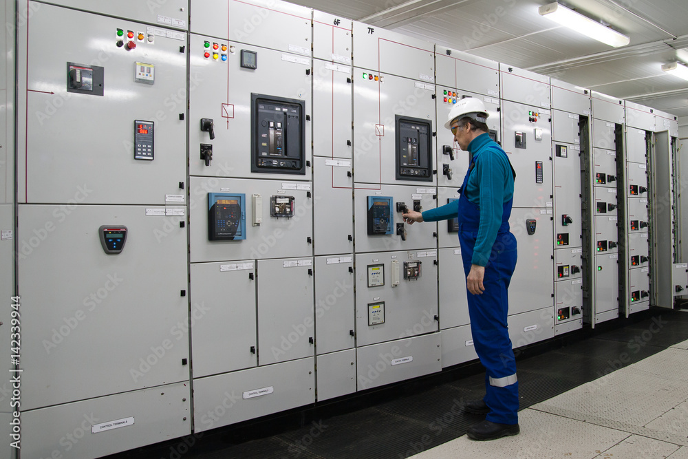 Man is in electrical energy distribution substation Man is in electrical energy distribution substation