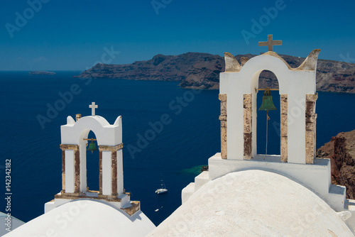 Architecture of island of Santorini, the most romantic island in the world, Greece. Travel to Greece. Beautiful white exterior Santorini. White church with bell tower 