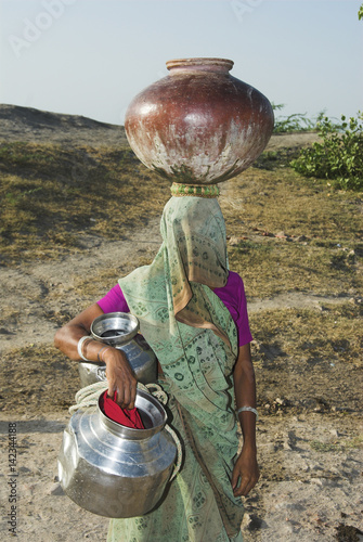 Little Rann of Kachchh (Kutch), Gujarat, India: A Rabari woman from Mulada village laboriously fetches water from the village dam photo