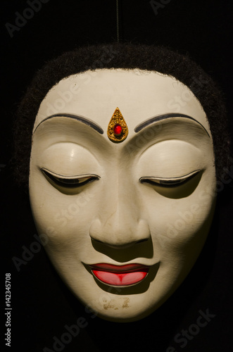 Traditional Balinese mask on a black background. photo