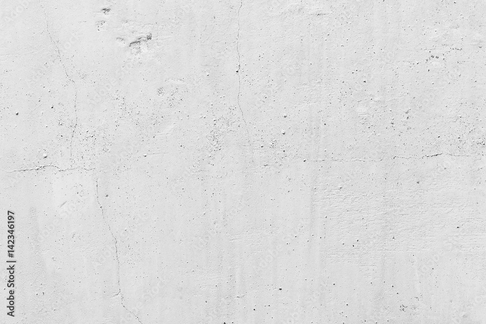 White concrete wall. Small cracks on the surface