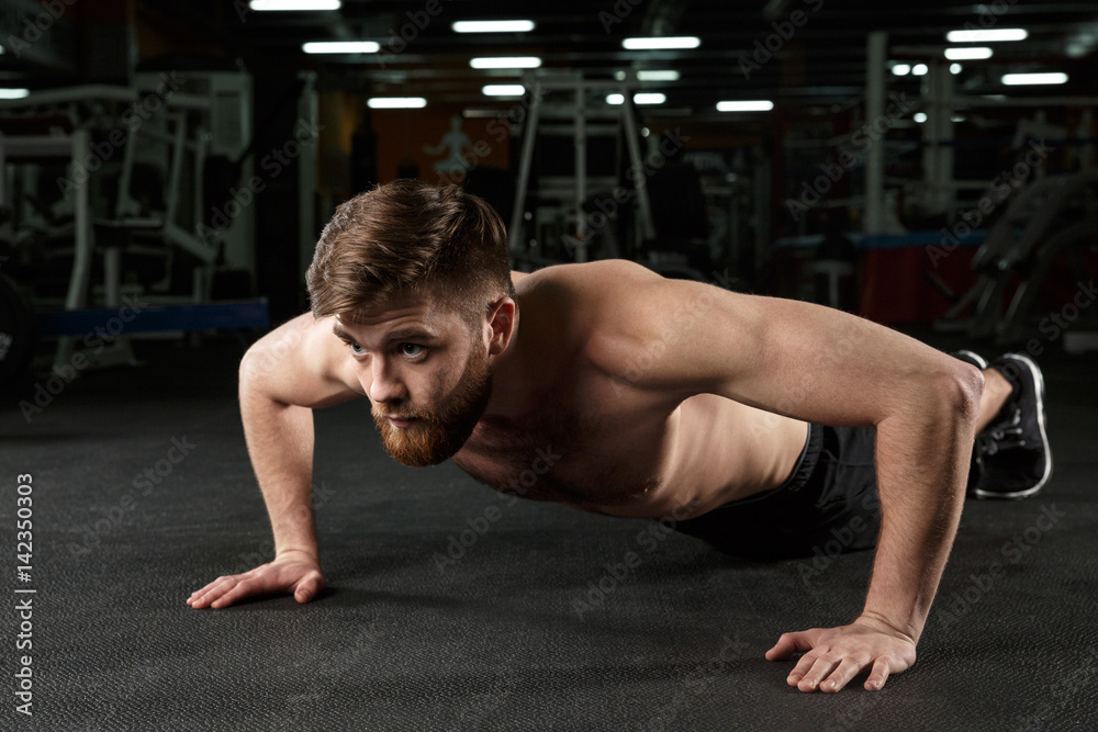 Concentrated young strong sports man make sport exercise Concentrated young strong sports man make sport exercise