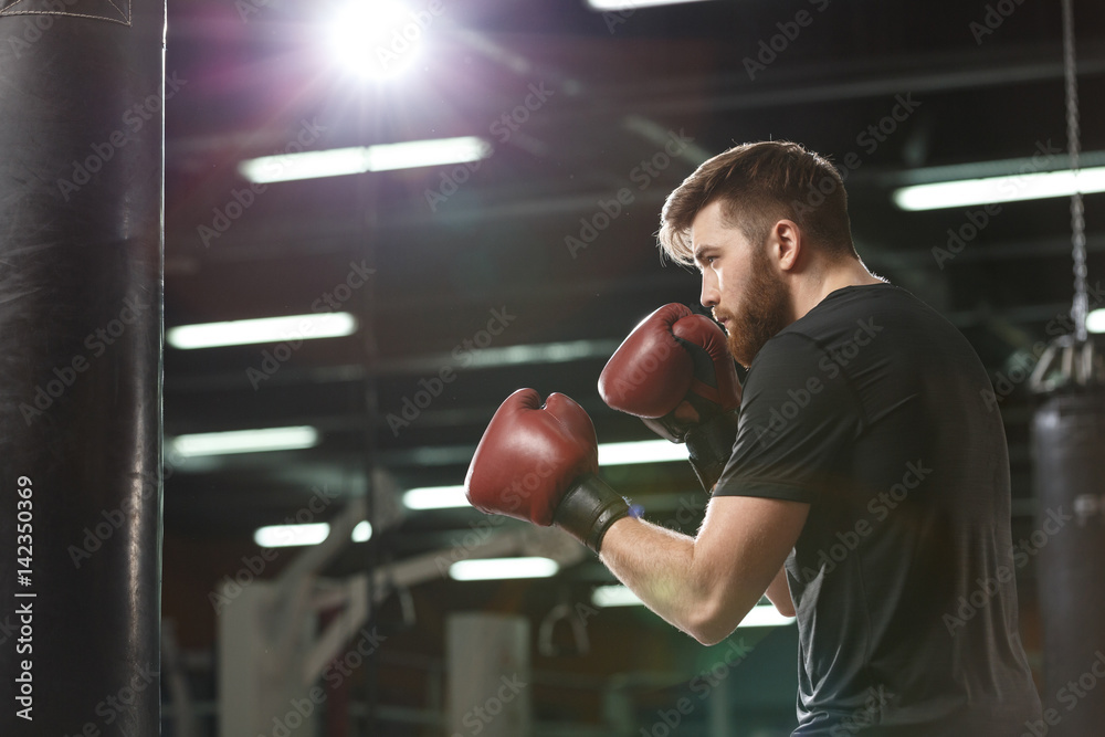 Handsome young strong sports man boxer make exercises