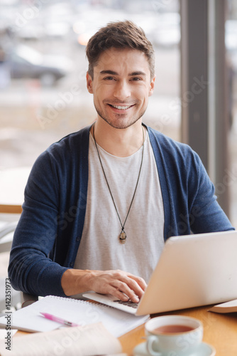 Young handsome guy working on computer