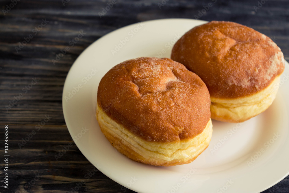 Berliner donuts on a wooden table in rustic style Berliner donuts on a wooden table in rustic style