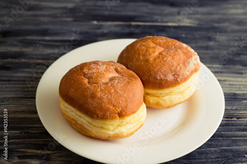 Berliner donuts on a wooden table in rustic style