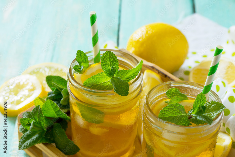 Iced tea with lemon and mint. Refreshing cold summer drink. Copy space. Iced tea with lemon and mint. Refreshing cold summer drink. Copy space.
