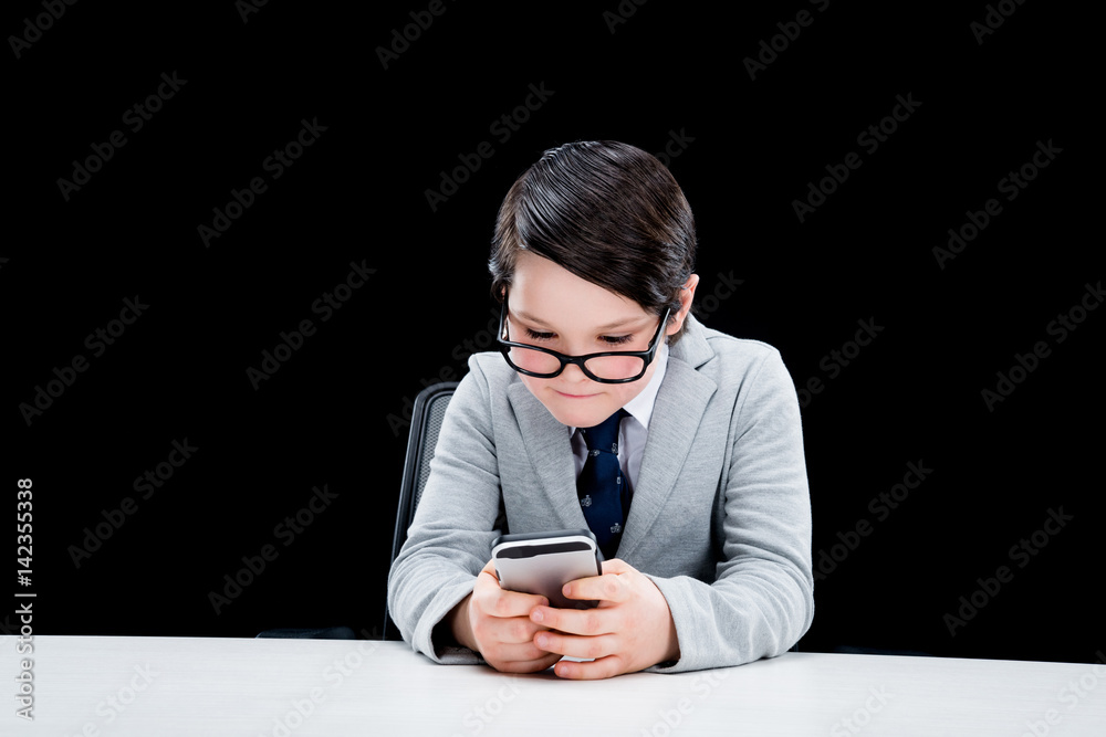 Boy pretending to be businessman and using smartphone Boy pretending to be businessman and using smartphone