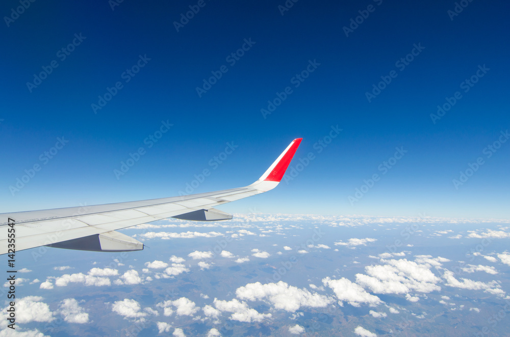 Fototapeta premium wing airplane with bluesky and clouds from window