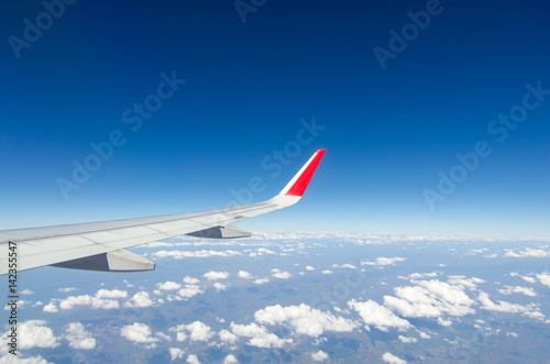 wing airplane with bluesky and clouds from window