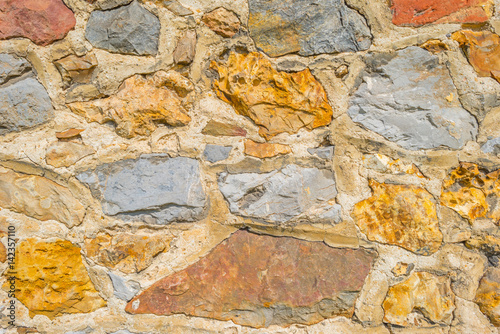 Wall of stones in sunlight photo