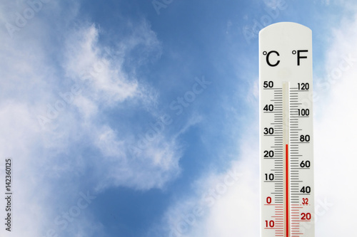 image of thermometer against blue sky