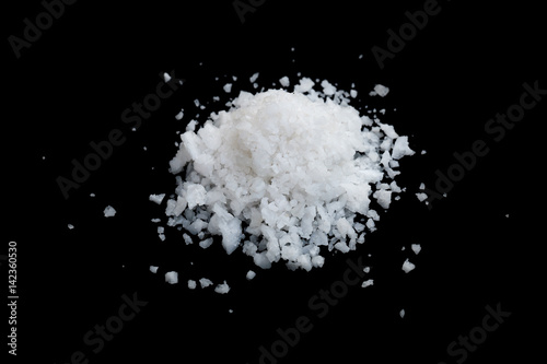 pile of white sea salt isolated on black
