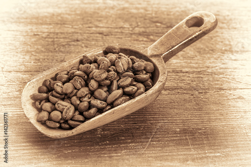 scoop of coffee beans in retro toning