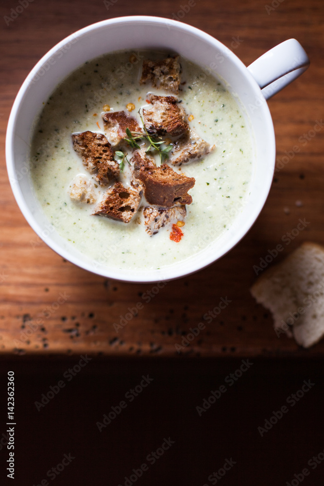 Cup of leek and potato soup with croutons Cup of leek and potato soup with croutons